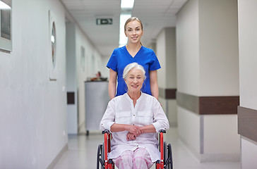 Image showing nurse with senior woman in wheelchair at hospital