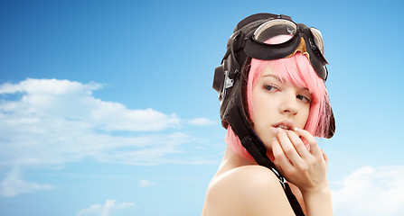 Image showing pink hair girl in aviator helmet over blue sky