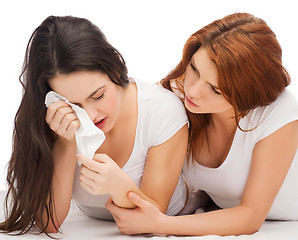 Image showing one teenage girl comforting another after break up