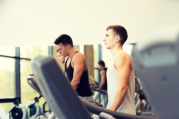 Image showing group of men exercising on treadmill in gym