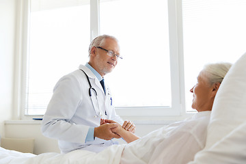 Image showing doctor checking senior woman pulse at hospital