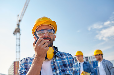 Image showing builder in hardhat with walkie talkie