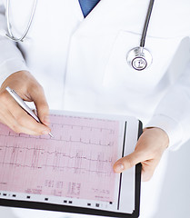 Image showing male doctor hands with cardiogram