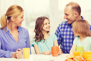 Image showing happy family with two kids with having breakfast