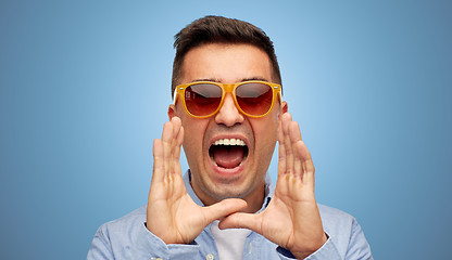 Image showing face of angry shouting man in shirt and sunglasses