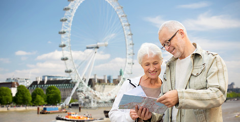 Image showing senior couple with map over london eye