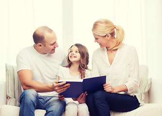 Image showing smiling parents and little girl with at home