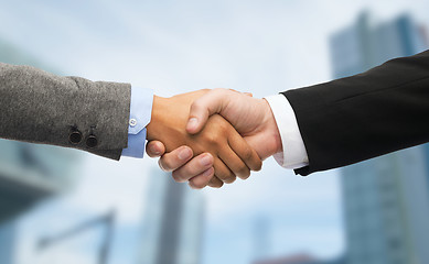 Image showing businessman and businesswoman shaking hands