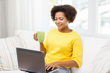 Image showing happy african american woman with laptop at home