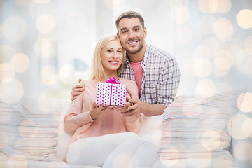 Image showing happy man giving woman gift box at home