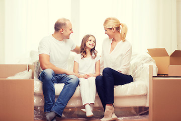 Image showing smiling parents and little girl at new home