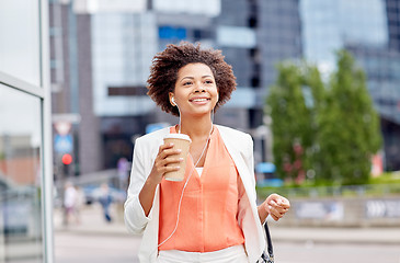 Image showing happy african businesswoman with coffee in city