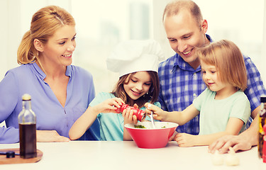 Image showing happy family with two kids making dinner at home