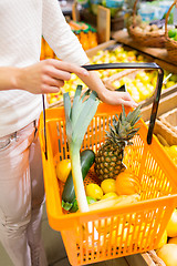 Image showing close up of woman with food basket in market