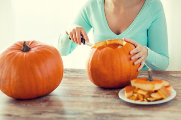 Image showing close up of woman with pumpkins at home