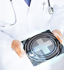 Image showing male doctor holding tablet pc with medical app