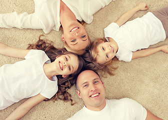 Image showing parents and two girls lying on floor at home