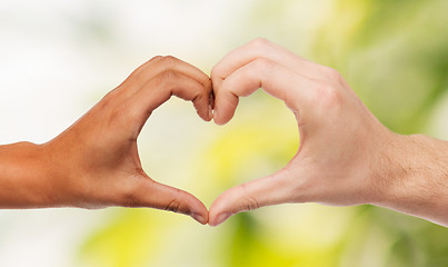 Image showing woman and man hands showing heart shape