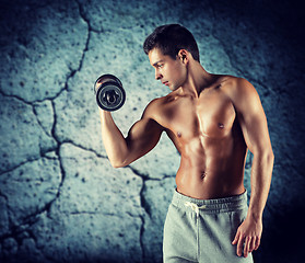 Image showing young man with dumbbell flexing biceps