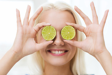 Image showing happy woman having fun covering eyes with lime