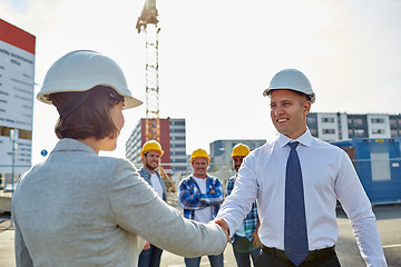 Image showing builders making handshake on construction site