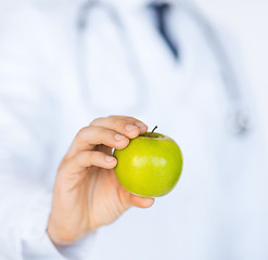 Image showing male doctor with green apple