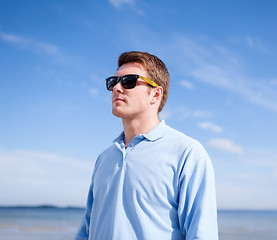 Image showing young man in sunglasses at summer beach