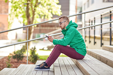 Image showing young hipster man with smartphone in city