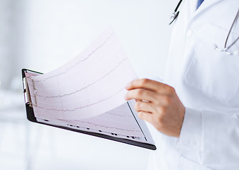 Image showing male doctor hands holding cardiogram