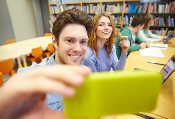 Image showing students with smartphone taking selfie in library