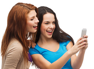 Image showing two smiling teenagers with smartphone