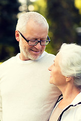 Image showing senior couple hugging in city park