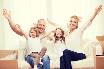 Image showing smiling parents and two little girls at new home