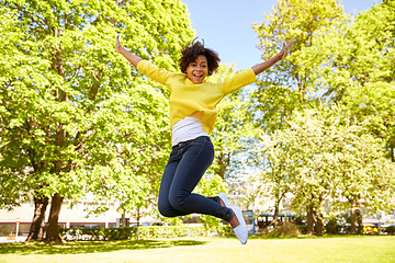 Image showing happy african american young woman in summer park