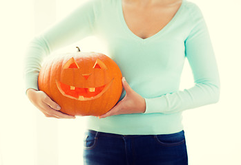 Image showing close up of woman with pumpkins at home