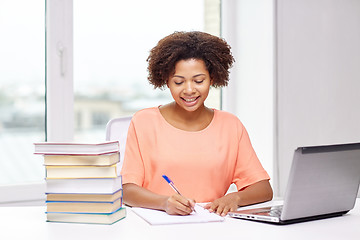 Image showing happy african american woman with laptop at home