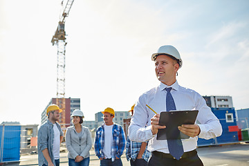 Image showing happy builders and architect at construction site