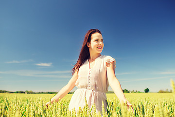 Image showing smiling young woman on cereal field