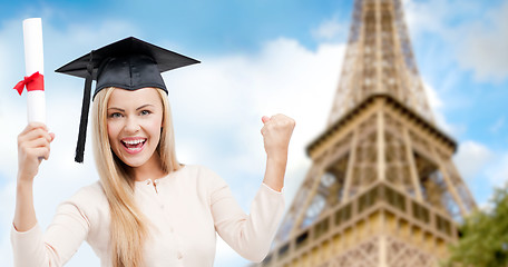 Image showing student in trencher with diploma over eiffel tower