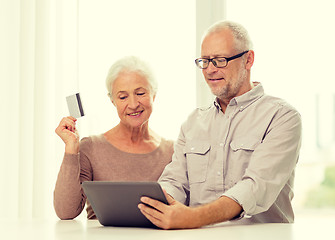 Image showing happy senior couple with tablet pc and credit card