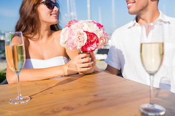 Image showing smiling couple drinking champagne at cafe