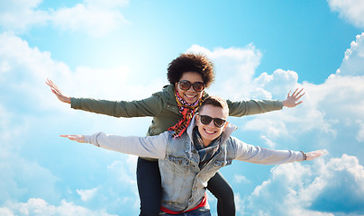 Image showing happy teenage couple in shades having fun outdoors