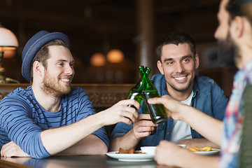 Image showing happy male friends drinking beer at bar or pub