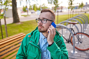 Image showing young hipster man with smartphone and byke