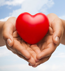 Image showing womans cupped hands showing red heart