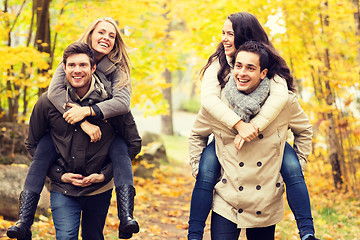 Image showing smiling friends having fun in autumn park