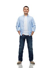 Image showing smiling man with hands in pockets