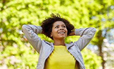 Image showing happy african american young woman in summer park