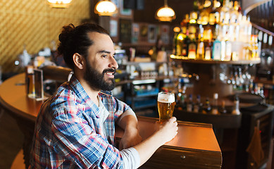Image showing happy man drinking beer at bar or pub