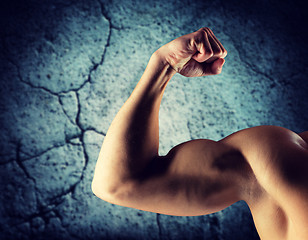 Image showing close up of young man flexing and showing biceps